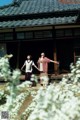 A couple of people standing in front of a building.